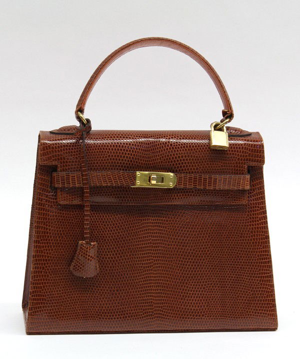 David R. Smith Bergdorf Goodman 28 brown reptile: David R. Smith for Bergdorf Goodman 30 cognac reptile Kelly bag with gilt hardware, lock and key in clochette, note: all measurements are in centimeters, 22h x 28w x 10d, handle drop 10. Provenance: P