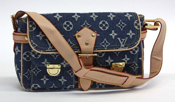 Louis Vuitton shoulder baguette: Louis Vuitton denim monogram shoulder baguette having double front pockets gilt hardware, 8"h x 11.5"w x 3.25"d. Provenance: Private Collection New York/Beverly Hills/London.