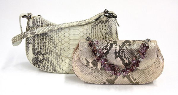 Stuart Weitzman reptile handbags: (lot of 2) Stuart Weitzman reptile handbags including a white snakeskin handbag, 5.5''h x 9''w x 3.25d, and a pale pink and metallic faux snakeskin handbag with a multi-colored beaded handle, 4''h x 8