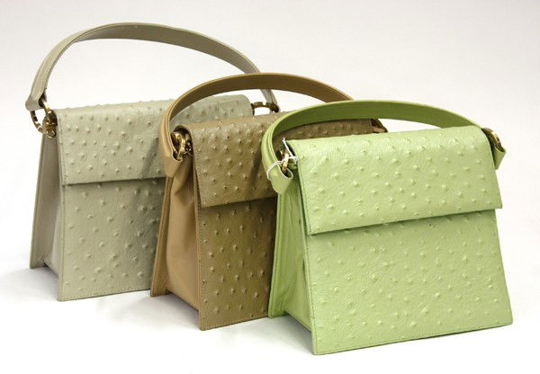 Charles Jourdon ostrich handbags: Three Charles Jourdan ostrich handbags with burnished gold toned hardware, one in ivory, one in beige, and one in pale green, 7.25''h x 8.25 ''w x 3.5''d, handle drop 4.5''