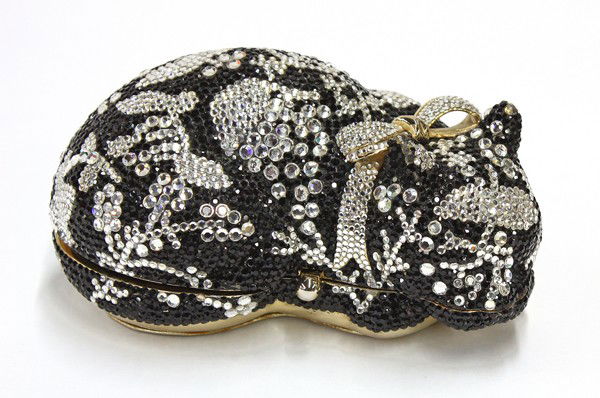 Judith Leiber beaded cat purs: Judith Leiber 'minaudiere' figural beaded clutch in the form of a sleeping cat, executed in black and silver crystals, opening to a gold toned leather interior, including a small mirror, change purse