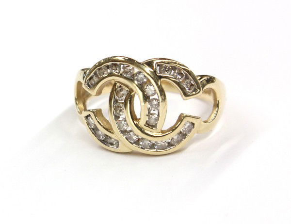 Diamond yellow gold ''CC'' ring: Diamond ''CC'' ring; of 14k yellow gold, set with (22) diamonds weighing approximately 0.50 ct. Total ring weight 4.2 grams. Ring size 7. Stamped AWAD 14K