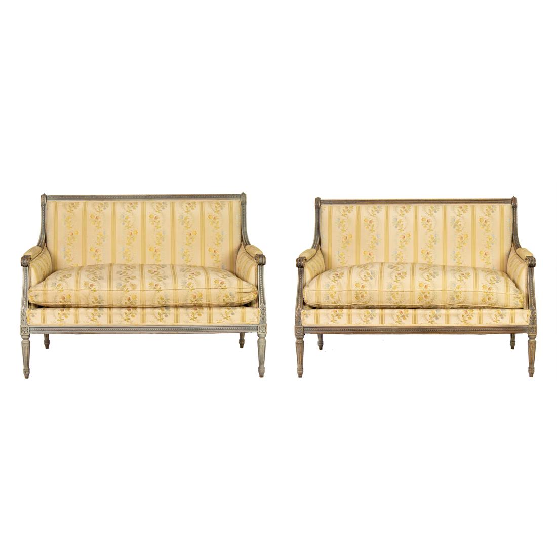 (Lot of 2) French Louis XVI style upholstered settees first half 19th century: (Lot of 2) French Louis XVI style upholstered settees first half 19th century, each with a carved and paint decorated frame, floral upholstery with down loose cushion, and rising on turned legs, overa
