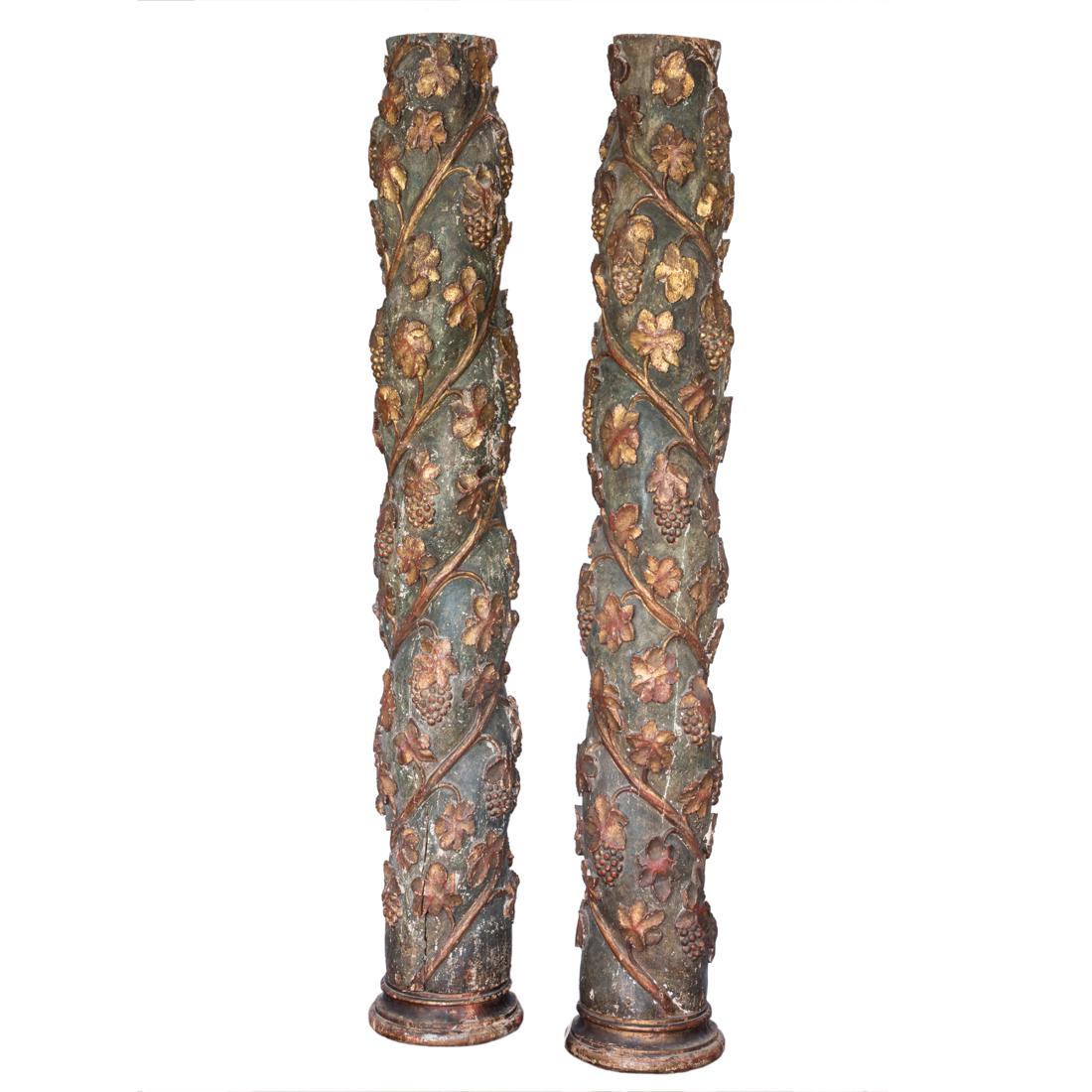 A pair of gilt gessoed carved wood Solomonic columns: A pair of gilt gessoed carved wood Solomonic columns, possibly Italian 18th century, each spiral column carved with grape leaves and fruited vines climbing and twisting around the standard, ending in 