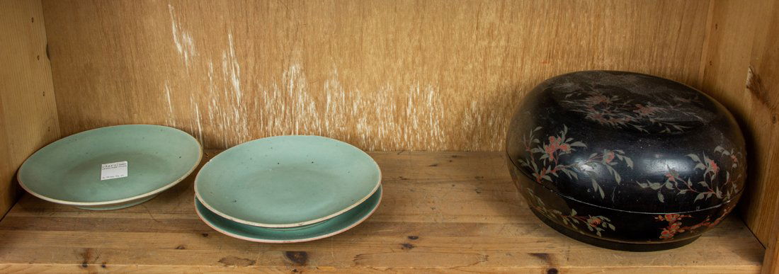 Shelf of Chinese decorations,: Shelf of Chinese decorations, comprising a lacquered box and three celadon glazed dishes, widest 11".