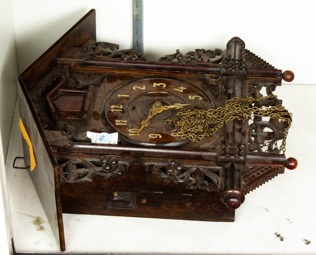 Cuckoo clock carved with vines: Cuckoo clock carved with vines, 16"h x 15"w.