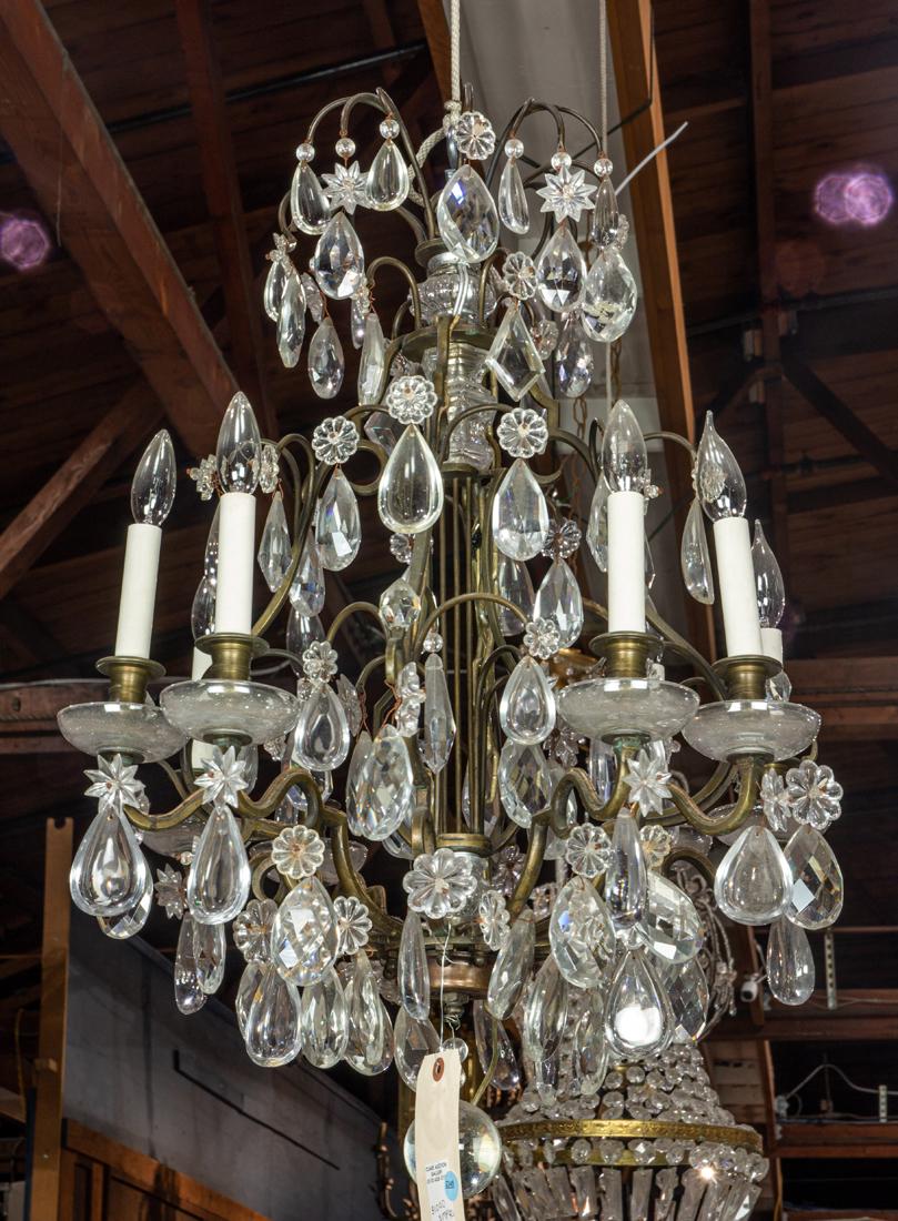Baroque style bronze and glass eight light chandlier: Baroque style bronze and glass eight light chandlier, hung with rosettes, prisims and orb, approximately 31"h x 23.75"dia.