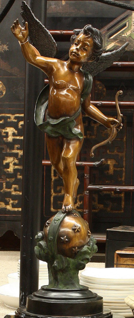 Pair of Eros sculptures: (lot of 2) Pair of patinated metal Eros sculptures, one having a bow and one holding a torch, each raised on a globe representing the heavens, studded with stars, each 32''h x 12''w x 14''d