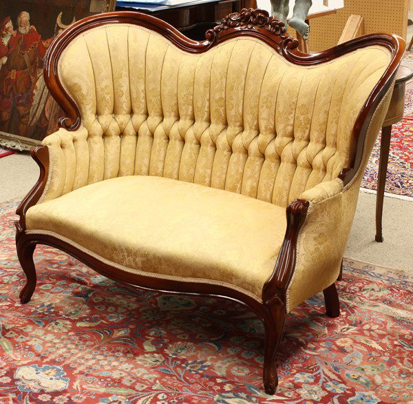 Victorian style settee: Victorian style settee, executed in the Rococo Revival taste, having a floral decorated crest above a channelled and tufted back, and rising on cabriole legs, 40''h x 52''w