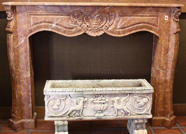 Louis XVI style fireplace surround: Louis XVI style painted wood fireplace mantle, the serpentine top above a hand carved surround centered with a shell form medallion, the sides with conforming reserves at the shoulder and rising on st