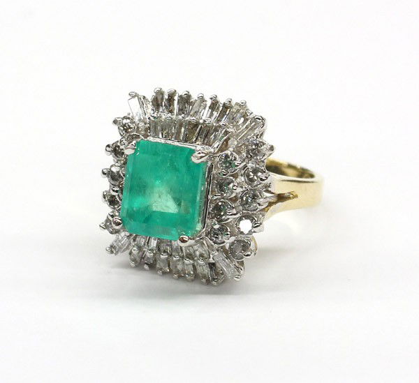 Emerald cut emerald diamond yellow white gold rin: Emerald and diamond dinner ring; of white and yellow gold (stamped) 14k, featuring (1) 19.8 x 8.38mm emerald-cut emerald, accented by (18) round full and (30) baguette cut diamonds, weighing in total