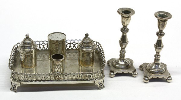 Portugese silver desk set: Portuguese .833 silver consisting of a reticulated gallery footed inkstand fitted with double covered wells, pounce container, and pen holder,; together with a pair of 5.75'' candle holders, 28.55 tro