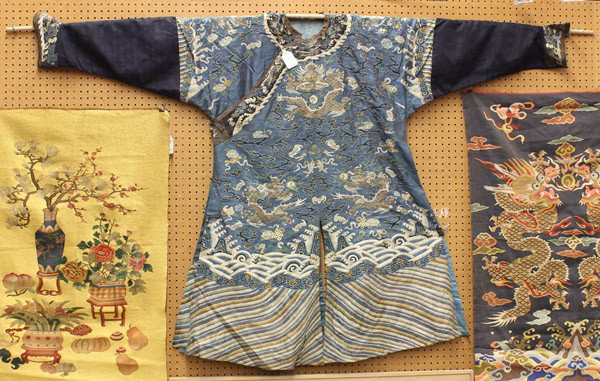 Chinese Woven Kesi Dragon Robe: Chinese blue ground woven kesi dragon robe (jifu), with nine five-claw dragons meandering amid stylized clouds and Buddhist emblems above cresting waves and lishui border band, the details heightened 