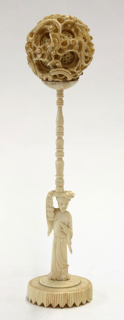 Chinese Ivory Puzzle Ball: Chinese ivory puzzle ball and stand, the exterior of the ball pierced and incised with meandering dragons encircling at least five additional reticulated layers, 2.125''w; together with a beauty fashi