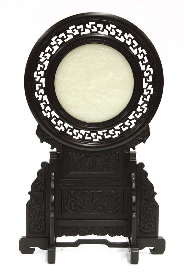 Chinese Jade Plaque Inset Wooden Table Screen: Chinese jade inset wooden table screen, featuring a circular jade plaque carved in relief with a pair of Mandarin ducks in a lotus pond, set within a pierced circular dark-hued wood frame supported by