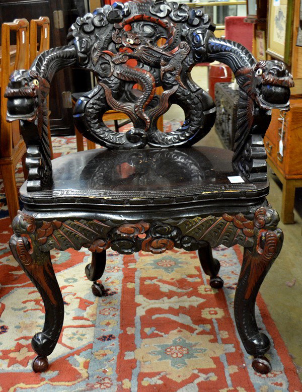 Japanese Export Dragon Chair: Japanese export armchair, carved with an openwork dragon meandering on the back splat and bracketed by dragon-form arms set into the shaped seat heightened with a key-fret band, raised on dragon form 