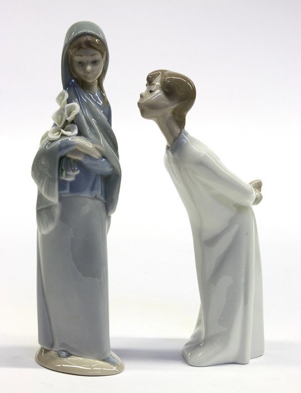 Lladro porcelain figurines: Two Lladro porcelain figurines including ''Boy Blowing'', 1974-1997, 7.75''h; together with a young girl holding calla lilies, 1969-1998, sculpted by Vicente Martinez, 9''