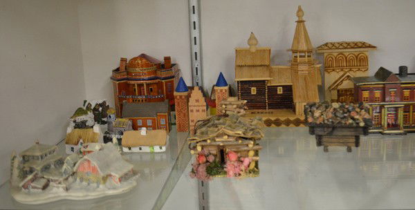 Architectural ceramic models: Four shelves of associated architectural models, including ceramic, composite, wood, styles include cottages, chalets, cabins, churches, taverns, shops, etc