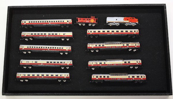 Marklin mini-club Z railroad engines carriages: One shelf of Marklin mini-club Z scale model railway engines and carriages, scale of 1:220, includes steam passenger with tender, diesel locomotive Santa Fe EMD F7, Union Pacific diesel engine, German