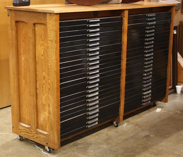 Print shop flat file: Hamilton print shop flat file with forty-eight drawers, each draweer designed to hold multiple lead types, housed in an oak case and raised on casters, 46.25''h x 72.25''w x 23.5''d