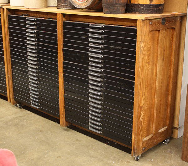 Print shop flat file: Hamilton print shop flat file with forty-eight drawers, each draweer designed to hold multiple lead types, housed in an oak case and raised on casters, 46.25''h x 72.25''w x 23.5''d