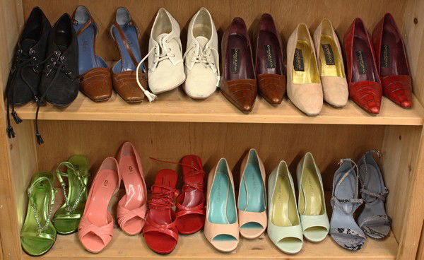 Designer shoes: Three shelves of associated pumps, sandals, stilettos, and boots including Max Mara, Donna Karan, Nine West, Bakers, and Stuart Weitzman in lipstick red, patent seafoam, periwinkle snakeskin, size 6.