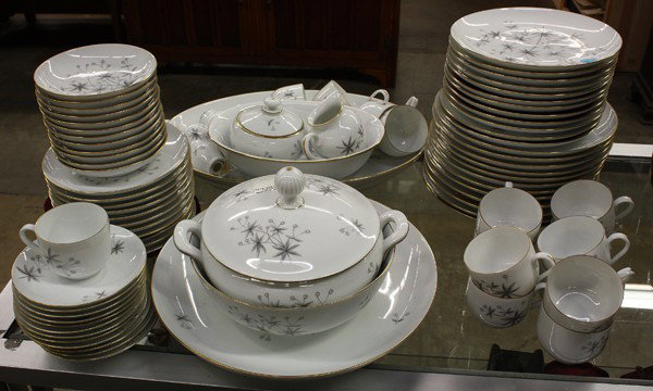 B&G table service: Bing and Grondahl table service for twelve, 1962-1970, of a white ground with grey stylized foliage and gilt rims, consisting of dinner plates, salad/dessert plates, bread plaes, berry bowls, cups, sa