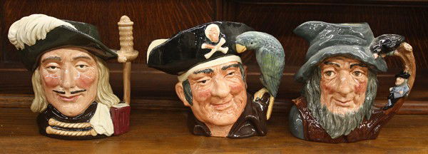 Royal Doulton Character Jugs: (lot of 12) Eleven Royal Doulton large character jugs consisting of ''Aramis,'' ''Auld Mac,'' ''Long John Silver,'' 'Rip Van Winkle,'' ''Veteren Motorist,'' ''Robinson Crusoe,'' ''Othelloe,'' ''Willia