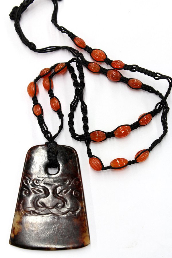 Jasper ax-head pendant black macrame necklace: Carved jasper ax-head pendant and black macrame necklace with melon cut carnelian bead accents