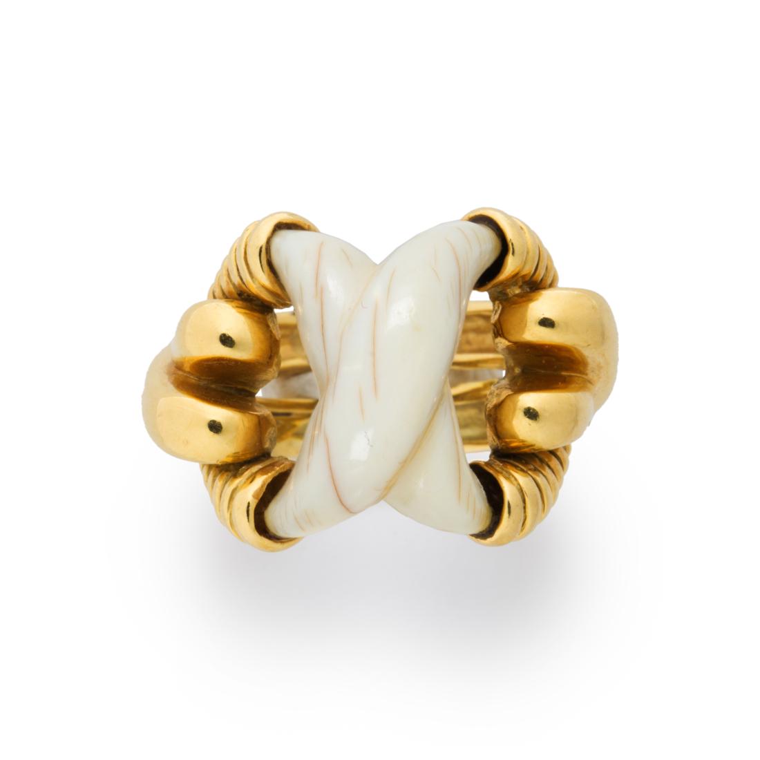 A bone and eighteen karat gold ring, Tiffany & Co.: A bone and eighteen karat gold ring, Tiffany & Co. designed as a carved bone of "X" form, set within gold mounting. 8.7 dwt; size: 5 1/2