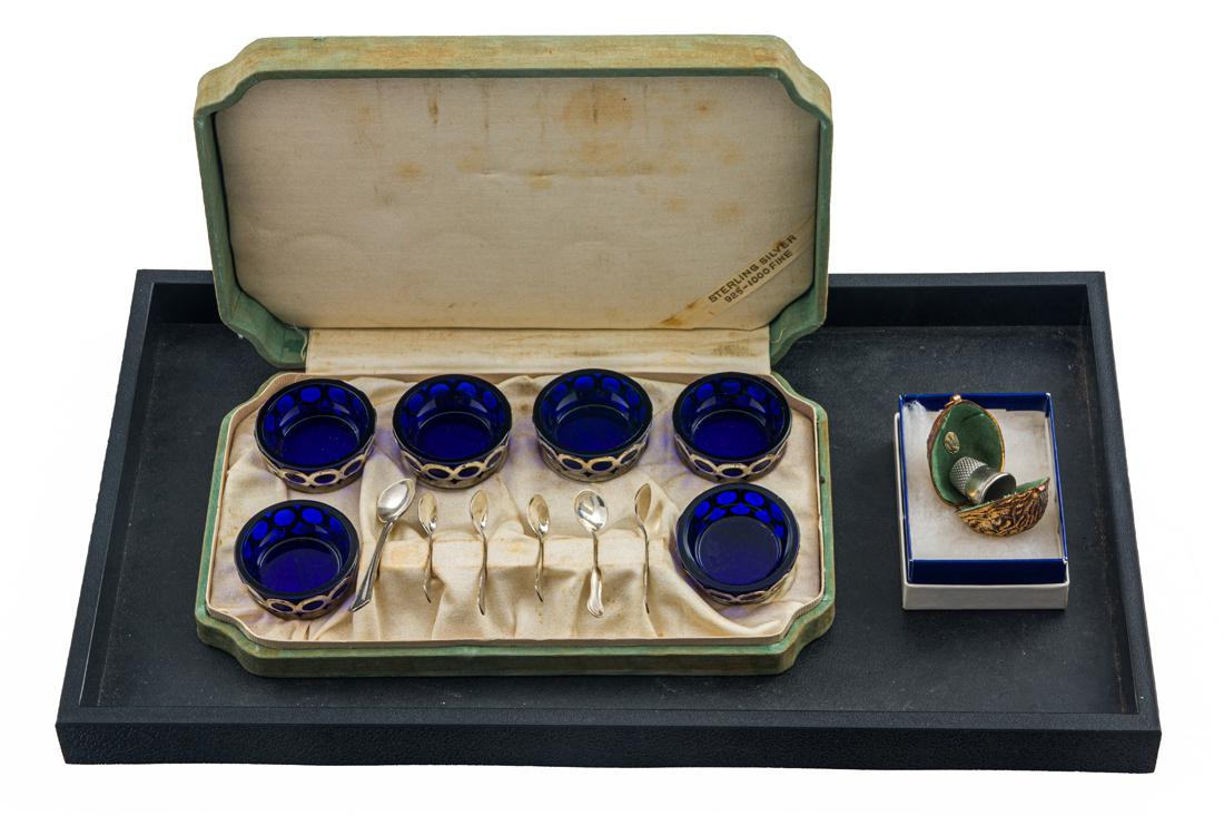 (6 pc) Webster cased set of reticulated sterling salts with cobalt blue glass liners; (6) sterling: (6 pc) Webster cased set of reticulated sterling salts with cobalt blue glass liners; (6) sterling salt spoons; together with a hinged Ernest Steiner gilt metal nut form needle case fitted with a thim
