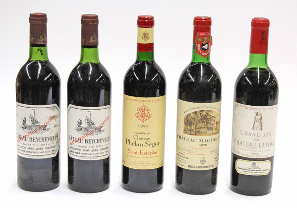 French wine group: (lot of 5) Bottles of French wine consisting of 1970 Chateau Magdelaine, 2 bottles of 1975 Chateau Beychevelle, Saint Julien, 1995 Chateau Phelan Segur Saint-Estephe, and 1968 Grand Vin de Chateau Lat