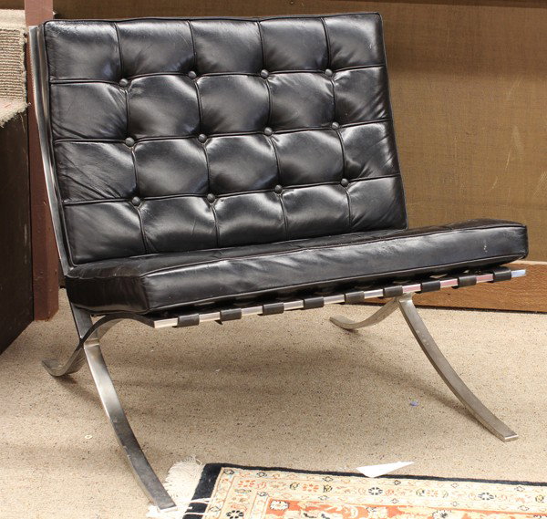 Pair Barcelona chairs: (lot of 2) Mies Van der Rohe style Barcelona chairs, having a chronium flat steel frame with black leather cushions stuffed with hard foam inserts, unsigned, 29''h x 31''w