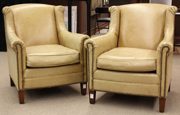 Leather Henredon easy chairs: Pair of Henredon leather club chairs, each having a wing back accented with brass nail head trim, continuing to the shaped arms and rising on square and tapered legs, 36''h x 32''w x 34''d