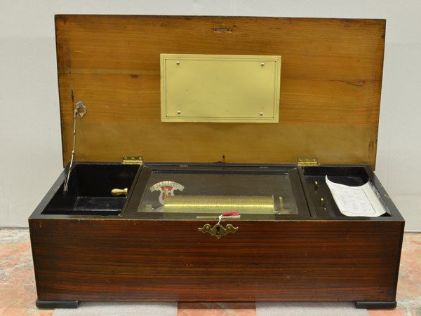 Continental music box: Continental music box, circa 1880, the rosewood case with satin wood string on the hinged top, and ebonized edges, the interior with a 7.5'' cylinder playing 20 tunes, 7.5''h x 24''w x 11.5''d