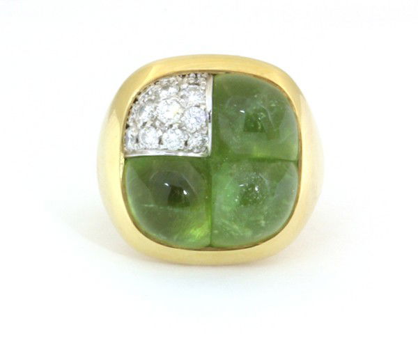 Peridot cabochon diamond Pomellato ring: Peridot cabochon and diamond ''Cut-to-Fit'' ring, by Pomellato; in 18k yellow gold, having pave set diamonds,weighing 0.58 ct. Total ring weight 26.9 grams. Ring size 5.75