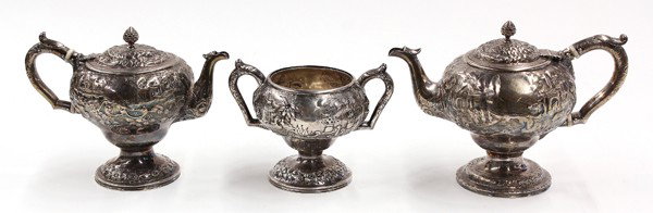 American sterling holloware service: American associated silver three piece silver hollowware service consisting of a sterling silver open sugar basin by Rand & Crane; and two silverplate teapots by S. Kirk, each incorporating chased and