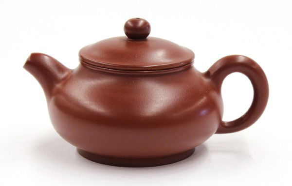 Chinese Zisha Teapot, Marked 'Gao Haigeng': Chinese ceramic zisha teapot, the compressed body incised 'zhenpin' under the loop handle opposed by a short spout, the recessed base incised 'Jingzhou zhi tu, Haigeng shou zhi' (=hand made by Haigeng