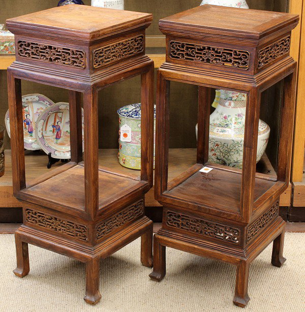Pair of Chinese Wood Flower Stands: Pair of Chinese hardwood flower stands, each with a square floating panel top within a ice-plate edge and high waist pierced with stylized scrollwork and stepped edge and slender supports framing the 