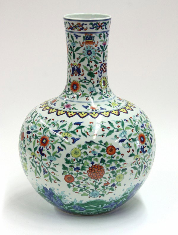 Chinese Large Doucai-style Stick-neck Vase: Chinese large doucai-style porcelain stick-neck vase, the globular body featuring multi-floral roundels amid further flowering leafy sprigs above cresting waves, with Buddhist emblems scattered amid b
