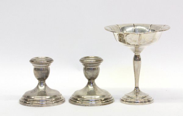 Silver table accessories: Three American sterling silver weighted table accessories including a pair of Wallace candle holders, 4''; together with a Preisner compote, 6''