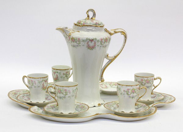 Demitasse service: J. Pouyat Limoges demitasse service for five including a covered chocolate pot, cups, saucers, and tray, retailed at S & G Gump Company