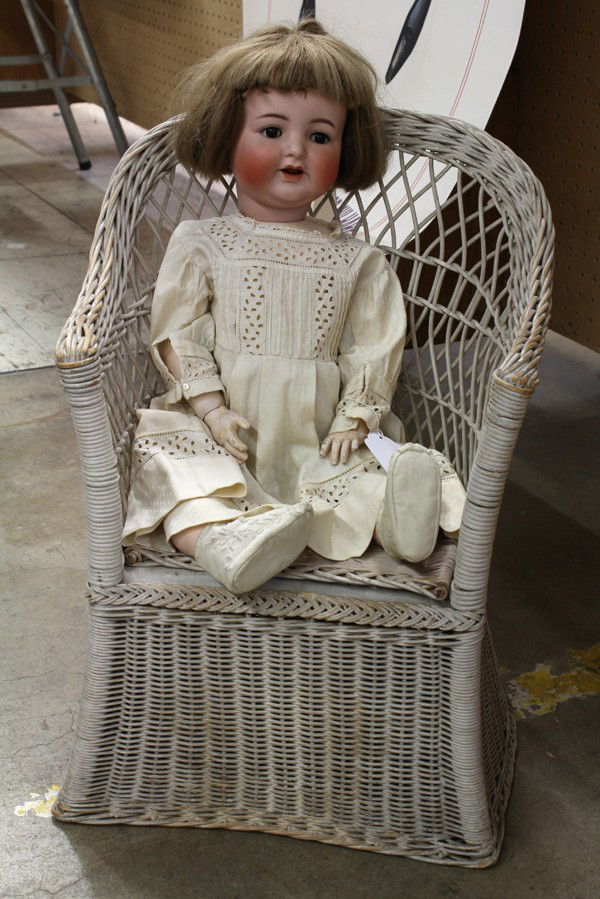 German bisque doll: German bisque socket head doll, Simon & Halbig 126,having hand-painted and naturalistic facial features surrounding brown sleep eyes and an open mouth with two upper teeth and tongue, attached to a jo
