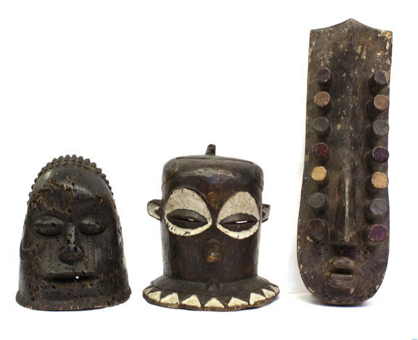 West African carvings: (lot of 3) West African carvings including a Pende style, D.R. Congo helmet mask; Grebo/Kru style, Liberia/Ivory Coast 'Eyes' mask; and a decorative helmet mask with coiled hair and facial scarificati
