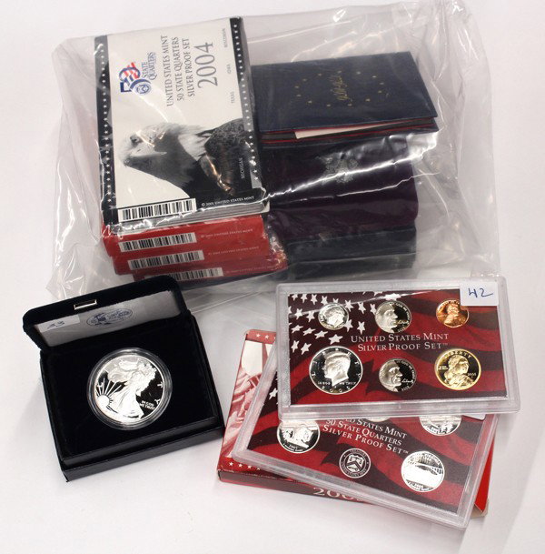 United States coin proof sets & silver dollars: (lot of 11) Associated United States proof coin sets and silver dollars, comprising of U.S. Mint Silver Proof Sets including 2001, 2003, 2004, 2005 and 2004 U.S. Mint State Proof set, U.S. Bicentennia