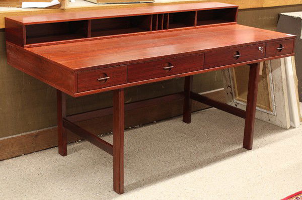 Quistgaard Lovig desk: Jens Quistgaard (1919-2008), Lovig desk circa 1960, executed in rosewood, the hinged galley top folding to create a very large work surface above a four drawer case and rising on rectangular legs, ret