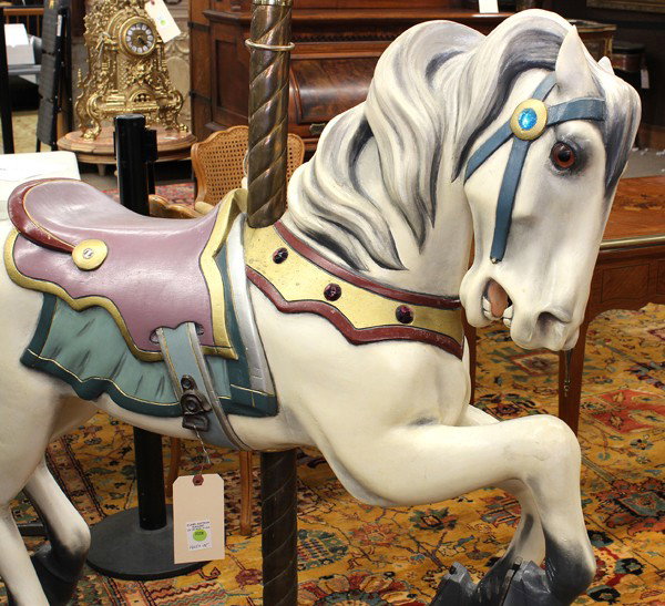 Allan Herschell company carousel horse: Allan Herschell company carousel horse, the sabino white mare is depicted in mid canter, the horse is outfitted with tack of various hues with gilt accents, the whole raised on a brass pole, horse and