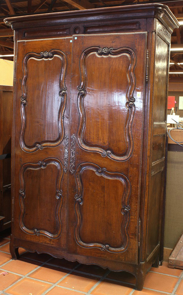French Louis Philippe oak armoire: French provincial Louis Philippe style oak armoire, circa 1850, with an ogee-molded cornice above a case fitted with two long doors, each inset with two shaped panels, with a scalloped apron below, ra