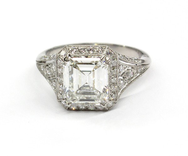 Solitaire Diamond Ring: Solitaire diamond ring; mounted in platinum, set with (1) emerald cut diamond weighing approximately 2.52 cts, (displaying: K color, SI1 clarity) accented by (62) diamonds weighing 0.64 ct. Total ring