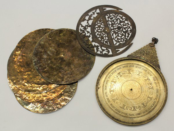 Islamic Brass Astrolabe, Inscribed: Islamic etched brass astrolabe, the astronomical instrument with a finely worked base (mater) intricately inscribed with various notations and the animals of the zodiac to either side, and suspended f